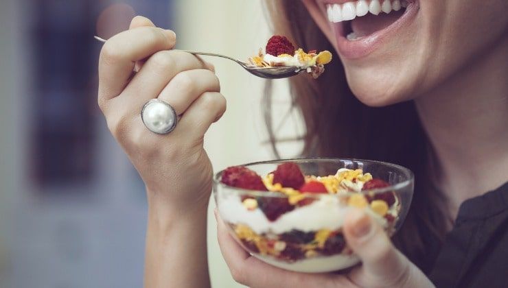 Giovane donna mangia colazione sana