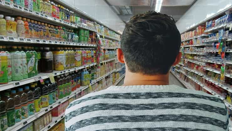 Man from behind in supermarket aisle